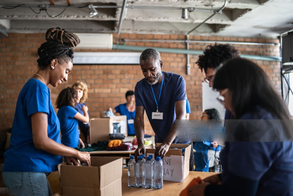 volunteers arranging donations in a community charity donation center